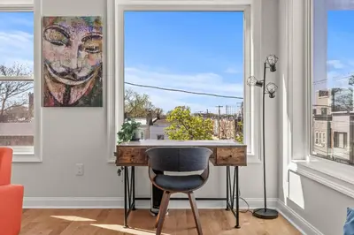 a desk with a chair in a room with a window at Skyline Escape in Philadelphia Chic & Bright in Philadelphia
