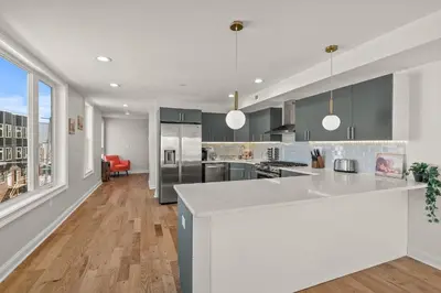 a kitchen with a large island in the middle at Skyline Escape in Philadelphia Chic & Bright in Philadelphia
