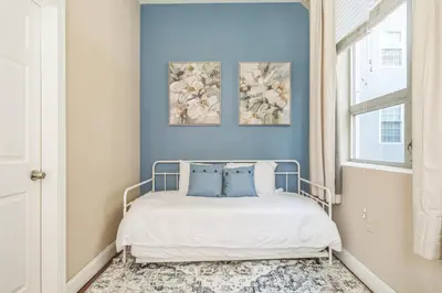 a bedroom with a bed with two paintings on the wall at Modern 2 bedroom - Center City Philadelphia in Philadelphia