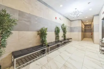 a lobby with a row of benches with plants at Modern 2 bedroom - Center City Philadelphia in Philadelphia