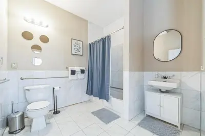 a bathroom with a toilet and a sink and a mirror at Modern 2 bedroom - Center City Philadelphia in Philadelphia