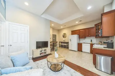 a kitchen and living room with a couch and a table at Modern 2 bedroom - Center City Philadelphia in Philadelphia