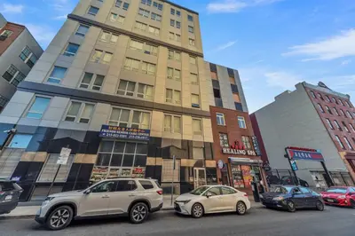 three cars parked in front of a tall building at Modern 2 bedroom - Center City Philadelphia in Philadelphia