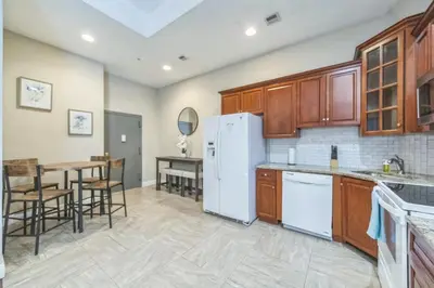 a kitchen with a white refrigerator and a table at Modern 2 bedroom - Center City Philadelphia in Philadelphia