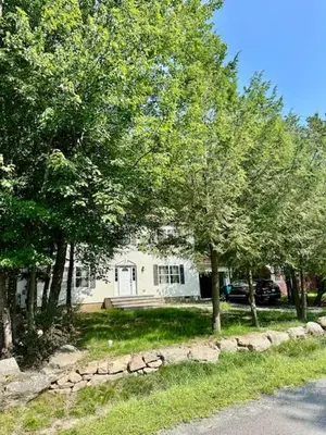 a white house with trees in front of it at Lakeview Family Retreat Newly Renovated 4BR House in Pocono Country Place