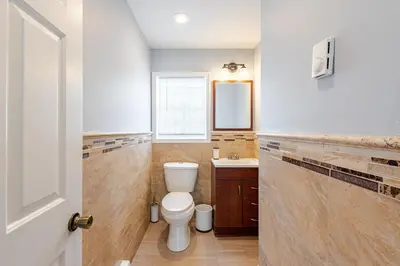 a bathroom with a toilet and a sink at Lakeview Family Retreat Newly Renovated 4BR House in Pocono Country Place