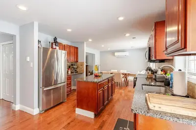 a kitchen with wooden cabinets and a stainless steel refrigerator at Lakeview Family Retreat Newly Renovated 4BR House in Pocono Country Place