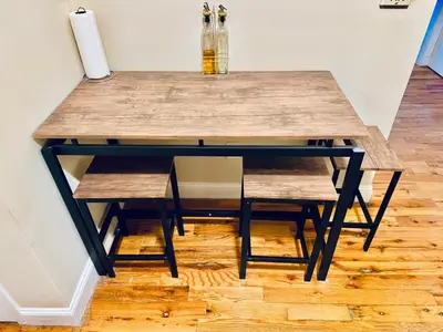 a wooden table with a bench and a table at Modern Luxury Executive Room with NYC Fast Access in Paterson