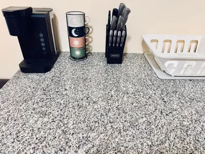 a counter top with a coffee cup and utensils at Modern Luxury Executive Room with NYC Fast Access in Paterson