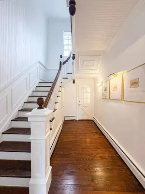 a hallway with a staircase in a house at 6000sf Luxe Estate Pond|Tennis|Sauna|Hottub|Movie in East Stroudsburg