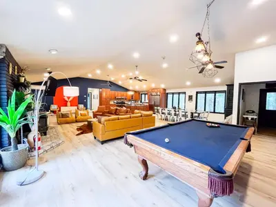 a living room with a pool table in it at 6bds|Secluded|Pool|Hot tub|Sauna|Games|Movie in Long Pond