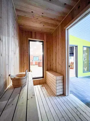 a wooden sauna with a bench and a window at 6bds|Secluded|Pool|Hot tub|Sauna|Games|Movie in Long Pond