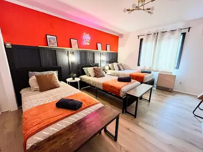 two beds in a room with red walls at 6bds|Secluded|Pool|Hot tub|Sauna|Games|Movie in Long Pond