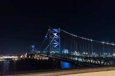 a large bridge over the water at night at Stay Like A Boss- Penthouse-Views- Convention Center- Free Parking in Philadelphia