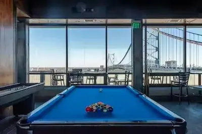 a pool table in a room with a view of a bridge at Stay Like A Boss- Penthouse-Views- Convention Center- Free Parking in Philadelphia