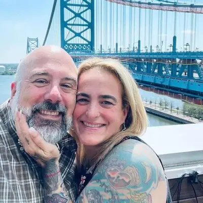 a man and a woman posing in front of a bridge at Stay Like A Boss- Penthouse-Views- Convention Center- Free Parking in Philadelphia