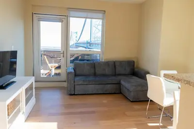a living room with a couch and a television at Stay Like A Boss- Penthouse-Views- Convention Center- Free Parking in Philadelphia