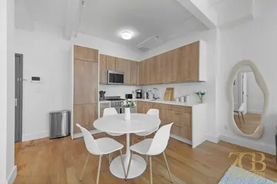 a kitchen and dining room with a table and chairs at 517 - 47C Beautifully Renovated 1 bedroom in Prime Manhattan in New York