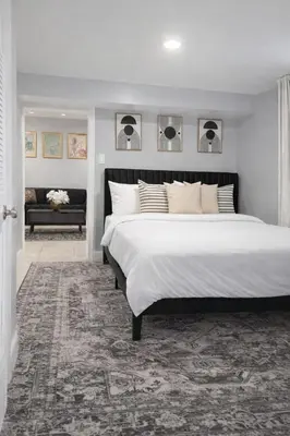 a bedroom with a large white bed and a couch at Modern Newark 1BR Apartment, Near Penn Station and EWR in Newark