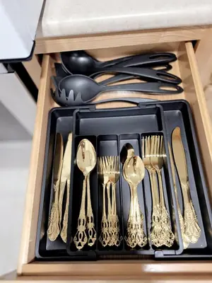 a drawer filled with silver teaspoons and forks and spoons at Modern Newark 1BR Apartment, Near Penn Station and EWR in Newark