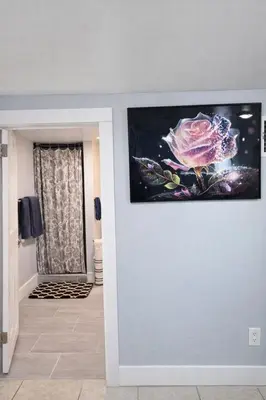 a living room with a painting on the wall at Modern Newark 1BR Apartment, Near Penn Station and EWR in Newark