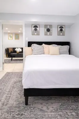 a bedroom with a large white bed and a couch at Modern Newark 1BR Apartment, Near Penn Station and EWR in Newark