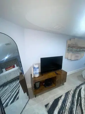 a room with a flat screen tv on a table at Cozy Home 422 South 16th street in Newark