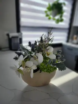 a bouquet of flowers in a vase on a counter at Luxury Floral Loft with Balcony Near MetLife & NYC in Bogota