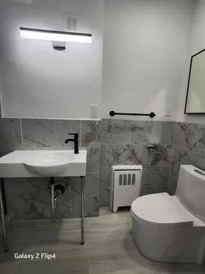 a bathroom with a sink and a toilet at Luxury Floral Loft with Balcony Near MetLife & NYC in Bogota