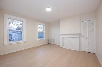 an empty living room with white walls and wood floors at Modern 3BR - Train Station & Downtown 2 mins walk in Rahway