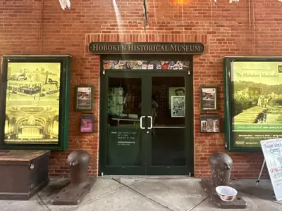 a brick building with a door to a historical museum at A Luxury Apartment in the Heart of Hoboken in Hoboken