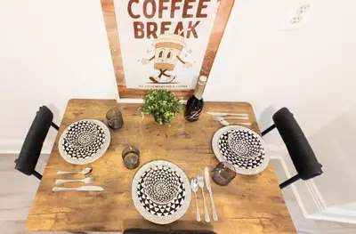 a table with a coffee break sign on top of it at A Luxury Apartment in the Heart of Hoboken in Hoboken