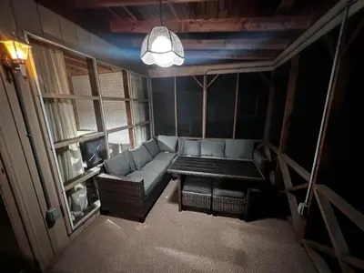a small living room with a couch and a table at Lakefront Paradise near everything! in Hawley
