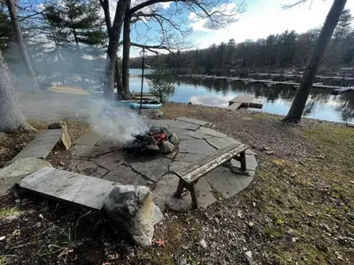a fire pit in a park with a picnic table at Lakefront Paradise near everything! in Hawley