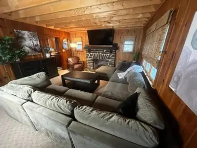 a living room with a couch and a fireplace at Lakefront Paradise near everything! in Hawley