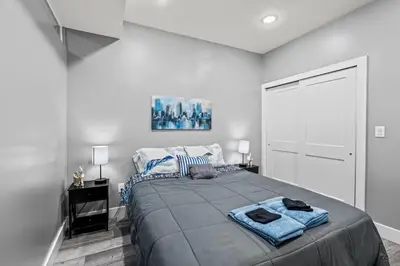 a bedroom with a large bed with blue towels on it at Elegant 1BR Stay Near Zoo & Downtown Philly in Philadelphia