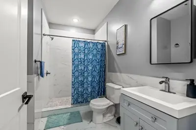 a bathroom with a shower and a toilet and a sink at Elegant 1BR Stay Near Zoo & Downtown Philly in Philadelphia