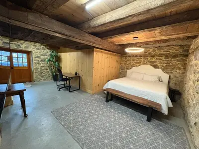 a bedroom with a bed and a desk in a room at Spacious Barn House experience! in Hellertown