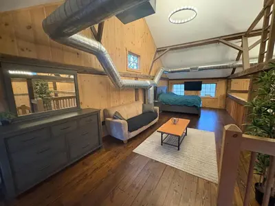 a living room with a couch and a table at Spacious Barn House experience! in Hellertown