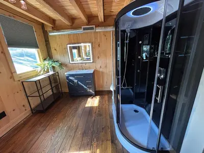 a bathroom with a shower in a tiny house at Spacious Barn House experience! in Hellertown