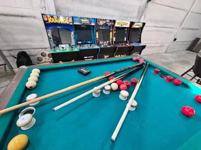 a pool table with balls and cues on it at Spacious Barn House experience! in Hellertown