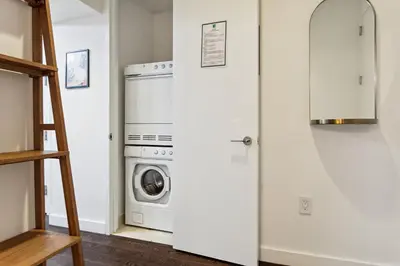 a laundry room with a washer and dryer at FiDi Studio with Work Setup by Anyplace - 8827 in New York