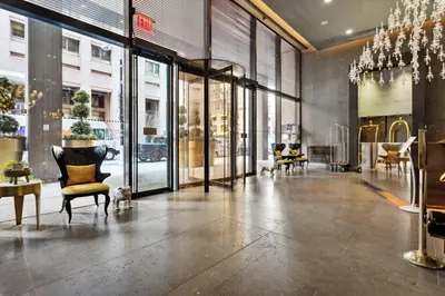 a lobby with chairs and tables in a store at FiDi Studio with Work Setup by Anyplace - 8827 in New York
