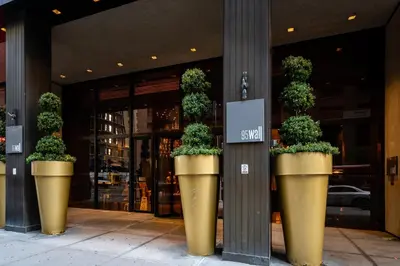 three large potted plants in front of a building at FiDi Studio with Work Setup by Anyplace - 8827 in New York