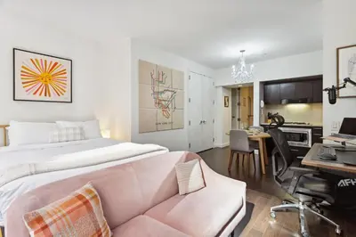 a bedroom with a king sized bed and a desk at FiDi Studio with Work Setup by Anyplace - 8827 in New York