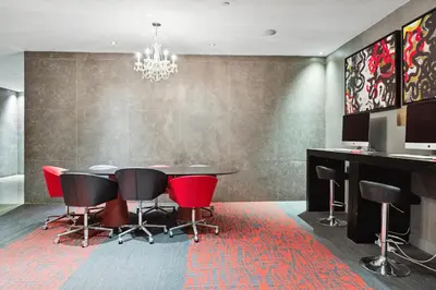 a dining room with a table and red chairs at FiDi Studio w Work Setup by Anyplace - 10250 in New York