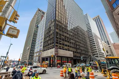 a group of construction workers on a busy city street at FiDi Studio w Work Setup by Anyplace - 10250 in New York