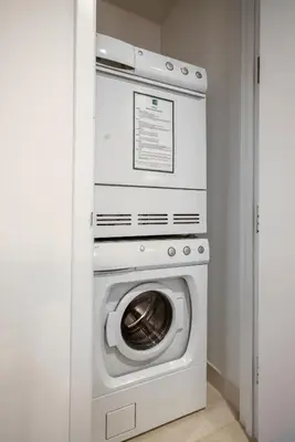 a white washer and dryer in a room at FiDi Studio w Work Setup by Anyplace - 10254 in New York