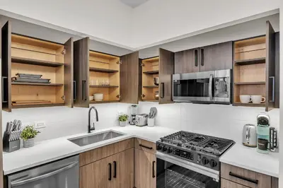 a kitchen with a sink and a stove top oven at FiDi Studio w Work Setup by Anyplace - 11679 in New York