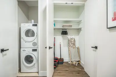 a laundry room with a washer and dryer at FiDi Studio w Work Setup by Anyplace - 11679 in New York